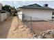 Backyard showing access to side yard, chain link fence, and desert landscaping at 4564 Dennis Way, Las Vegas, NV 89121