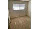 Simple bedroom with neutral carpet, single window, and a door at 4564 Dennis Way, Las Vegas, NV 89121