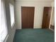 Cozy bedroom featuring plush blue carpet, double door closet, and natural light from a window at 4564 Dennis Way, Las Vegas, NV 89121