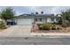 Charming single-story home with a well-maintained lawn, complemented by solar panels and a two car garage at 4564 Dennis Way, Las Vegas, NV 89121