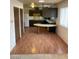 A kitchen with wood cabinets, modern appliances and wood floors at 4564 Dennis Way, Las Vegas, NV 89121