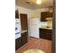 Kitchen with wood cabinets, white refrigerator and oven at 4564 Dennis Way, Las Vegas, NV 89121