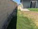 Well-maintained backyard featuring a partial lawn, block wall, and low-maintenance landscape at 4778 Beadle St, Las Vegas, NV 89122