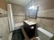 Full bath featuring shower-tub combo, dark wood vanity, and tiled walls at 4778 Beadle St, Las Vegas, NV 89122