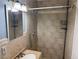 Tiled shower with a neutral vanity and framed mirror at 4778 Beadle St, Las Vegas, NV 89122