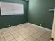 Minimalist bedroom featuring green walls, tiled floors and a bright window at 4778 Beadle St, Las Vegas, NV 89122