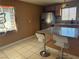 Eat in kitchen with counter seating, stainless appliances, light wood cabinets, and bright granite countertops at 4778 Beadle St, Las Vegas, NV 89122