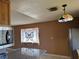 Eat in kitchen with stained glass lighting fixture, stainless appliances and bright granite countertops at 4778 Beadle St, Las Vegas, NV 89122