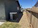 Side yard featuring low-maintenance desert rock and wood privacy fence at 4778 Beadle St, Las Vegas, NV 89122