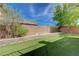 Lush artificial grass and mature trees add to the beauty of this backyard at 484 Merseyside Dr, Las Vegas, NV 89178