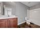 This bathroom features a vanity with white countertops and dark wood cabinets and a shower-tub combination at 484 Merseyside Dr, Las Vegas, NV 89178