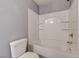 This bathroom features a white shower-tub combination with built in shelving and gray walls at 484 Merseyside Dr, Las Vegas, NV 89178