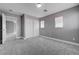 This bedroom features neutral gray carpeting and gray walls with baseboard trim and a closet at 484 Merseyside Dr, Las Vegas, NV 89178