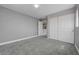 This bedroom features neutral gray carpeting and gray walls with baseboard trim and a closet at 484 Merseyside Dr, Las Vegas, NV 89178