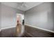 Spacious bedroom featuring hardwood floors, neutral walls, white trim, and two doorways to other rooms at 484 Merseyside Dr, Las Vegas, NV 89178