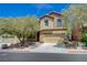 Inviting two-story home featuring neutral stucco, a two car garage, and a manicured front yard at 484 Merseyside Dr, Las Vegas, NV 89178