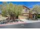 Inviting two-story home featuring neutral stucco, a two car garage, and a manicured front yard at 484 Merseyside Dr, Las Vegas, NV 89178