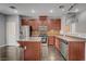 A modern kitchen featuring stainless steel appliances, a central island, and wood cabinets at 484 Merseyside Dr, Las Vegas, NV 89178