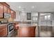 Open concept kitchen with stainless steel appliances, wood island, and hardwood floors at 484 Merseyside Dr, Las Vegas, NV 89178