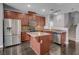 Well-equipped kitchen featuring stainless steel appliances, wood cabinets and island at 484 Merseyside Dr, Las Vegas, NV 89178