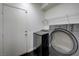 This laundry room features white walls, a wire shelf, and new front loading washer and dryer at 484 Merseyside Dr, Las Vegas, NV 89178