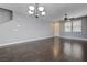 Bright living room with wood floors, ceiling fan and a modern chandelier at 484 Merseyside Dr, Las Vegas, NV 89178