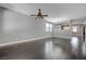 Open-concept living room with new hardwood floors and a ceiling fan at 484 Merseyside Dr, Las Vegas, NV 89178