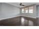Spacious living room with wood floors, a ceiling fan, and plenty of natural light at 484 Merseyside Dr, Las Vegas, NV 89178