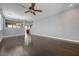 Open-concept living room with new hardwood floors and a ceiling fan at 484 Merseyside Dr, Las Vegas, NV 89178