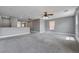 Spacious loft area with neutral carpeting, ceiling fan, two windows, and view of the second story at 484 Merseyside Dr, Las Vegas, NV 89178