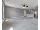 Expansive loft area features neutral carpeting, ceiling fan, with access to multiple rooms and a view of the upper level at 484 Merseyside Dr, Las Vegas, NV 89178