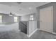 Upstairs loft area with neutral carpet, staircase with half wall, and ample open space, perfect for recreation at 484 Merseyside Dr, Las Vegas, NV 89178