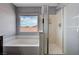 Tiled shower, soaking tub, and view from the main bathroom at 484 Merseyside Dr, Las Vegas, NV 89178