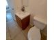 A bathroom features tile floors, a wood cabinet, and a clean white toilet at 4955 Jeffreys St # 403, Las Vegas, NV 89119