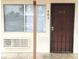 Unit 403's front entrance showcases a security door, window, and convenient access to air conditioning at 4955 Jeffreys St # 403, Las Vegas, NV 89119