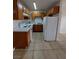 A functional kitchen features white appliances, wood cabinets and ample countertop space at 4955 Jeffreys St # 403, Las Vegas, NV 89119