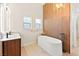 Stylish bathroom with contemporary soaking tub and modern wood accent wall at 5009 Elm Grove Dr, Las Vegas, NV 89130