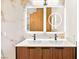 Modern bathroom featuring double vanity sinks, decorative mirrors, and marble accent at 5009 Elm Grove Dr, Las Vegas, NV 89130