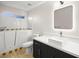 Bathroom with walk-in bathtub, white countertops, and dark cabinetry at 5009 Elm Grove Dr, Las Vegas, NV 89130