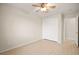 Bedroom with wood-look tile, closet with sliding doors, ceiling fan, and neutral paint at 5009 Elm Grove Dr, Las Vegas, NV 89130