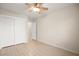 Bedroom with wood-look tile, closet with sliding doors, ceiling fan, and neutral paint at 5009 Elm Grove Dr, Las Vegas, NV 89130