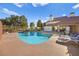 Community pool area with lounge chairs and tables for residents to enjoy at 5009 Elm Grove Dr, Las Vegas, NV 89130