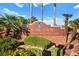 Los Prados Community & Country Club sign surrounded by lush landscaping and palm trees at 5009 Elm Grove Dr, Las Vegas, NV 89130