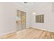 Bright dining area with wood floors, modern lighting fixture, and access to the backyard at 5009 Elm Grove Dr, Las Vegas, NV 89130