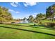 Scenic golf course view with lush green grass, a pond with a fountain, and trees at 5009 Elm Grove Dr, Las Vegas, NV 89130