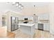Modern kitchen with white cabinetry, stainless steel appliances, a center island, and ample counter space at 5009 Elm Grove Dr, Las Vegas, NV 89130