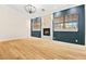 Spacious living room featuring wood floors, a fireplace, and two large windows at 5009 Elm Grove Dr, Las Vegas, NV 89130