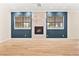 Spacious living room with wood floors featuring a fireplace and large windows at 5009 Elm Grove Dr, Las Vegas, NV 89130