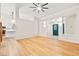 Open-concept living room featuring light wood floors, neutral walls, and ample natural light from the windows at 5009 Elm Grove Dr, Las Vegas, NV 89130