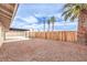 Spacious backyard featuring stone landscape, covered patio and mature palm trees at 516 Donner St, Las Vegas, NV 89107